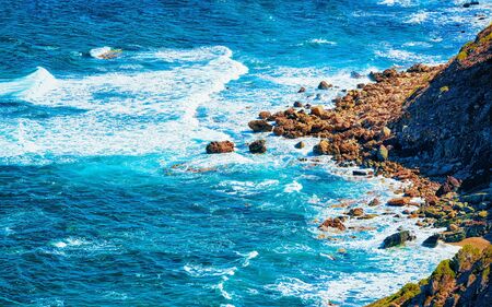 Porto Corallo in Nebida and coast Mediterranean Sea Sardinia reflex