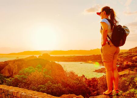 Girl looking at Capo Ferro on Costa Smeralda Sardinia Italy reflexの写真素材