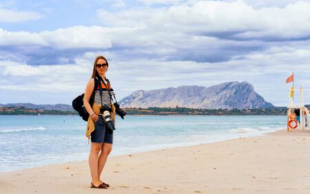 Girl with photo cameras at La Cinta beach reflexの写真素材