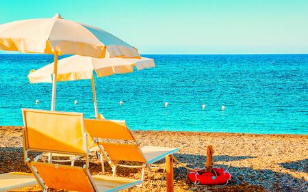 Landscape of Chia Beach with umbrellas and Blue Waters of the Mediterranean Sea in Province of Cagliari in South Sardinia in Italy. Scenery and nature. Mixed media.の写真素材
