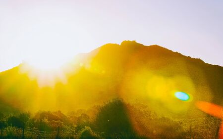 Rural landscape. Beautiful sunset or sunrise above vineyards in Perdaxius, Carbonia-Iglesias. Panorama in South Sardinia island of Italy. Scenery of Sardegna in summer. Cagliari province. Mixed media.の写真素材