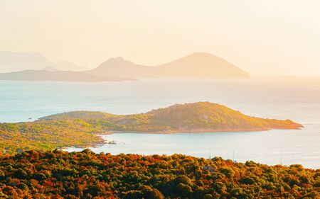 Scenery with Porto Rotondo at sunrise or sunset at the Mediterranean Sea. Porto Cervo in Sardinia Island in Italy in summer. Landscape on Sardegna. Sardinian Olbia province. Mixed media.の写真素材