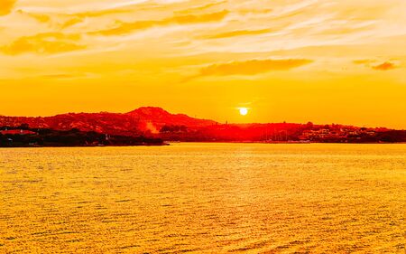 Scenery with Porto Rotondo at sunrise or sunset at Mediterranean Sea on Costa Smeralda. Porto Cervo in Sardinia Island in Italy in summer. Landscape on Sardegna. Sardinian Olbia province. Mixed media.の写真素材