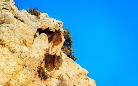 Rural landscape with hills and highland. Mountains in form of head with nose and eyes. Panorama in Sardinia island at Italy. Scenery of Sardegna, summer. Olbia province. Mixed media.の写真素材
