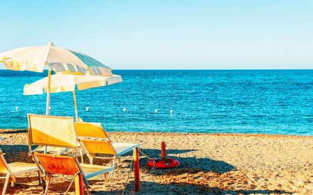 Landscape of Chia Beach with umbrellas and Blue Waters of the Mediterranean Sea in Province of Cagliari in South Sardinia in Italy. Scenery and nature. Mixed media.の写真素材