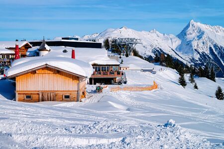 Restaurant and cafe chalet house on Penken ski resort in Tyrol in Mayrhofen in Zillertal valley in Austria in winter Alps. At Alpine mountains with white snow and blue skyの写真素材