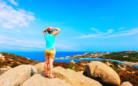 Woman and Landscape with Rocky coast of Capo Testa in Santa Teresa Gallura at the Mediterranean Sea on Sardinia Island in Summer Italy. Girl and Scenery of Cagliari province. Mixed media.の写真素材