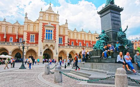 Krakow, Poland - May 1, 2014: People at Adam Mickiewicz and Cloth Hall in the Main Market Square, Krakow, Poland. Mixed media.のeditorial素材