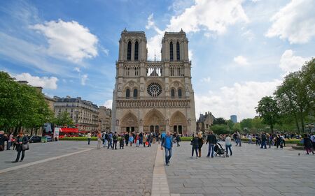 Paris, France - May 3, 2012: People at Notre Dame de Paris Cathedral in Paris, in France. Or Cathedral of Our Lady of Paris in English. It is one of the most known churches in the world. Mixed media.のeditorial素材