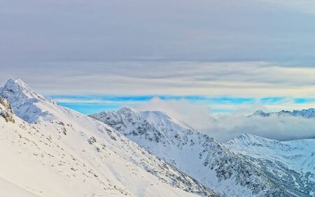 Clouds over Kasprowy Wierch of Zakopane in Tatra Mounts in winter. Zakopane is a town in Poland in Tatra Mountains.Kasprowy Wierch is a mountain in Zakopane and is the most popular ski areas in Poland. Mixed media.の写真素材