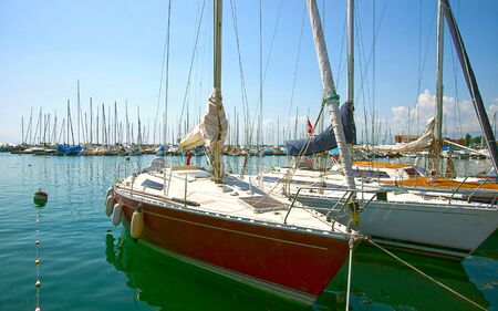 Boats in marina in Geneva lake bay harbor in Lausanne, Switzerland in summer. Mixed media.の写真素材