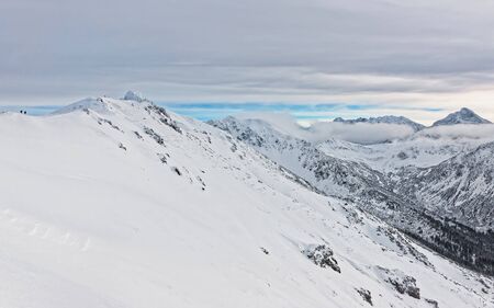 Clouds in the Kasprowy Wierch of Zakopane in Tatra Mounts in winter.Zakopane is a town in Poland in Tatra Mountains.Kasprowy Wierch is a mountain in Zakopane and is the most popular ski area in Poland. Mixed media.の写真素材