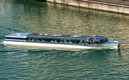 Zurich, Switzerland - September 2, 2016: Excursion boat with tourists in Limmat River in Zurich, Switzerland. Mixed media.のeditorial素材