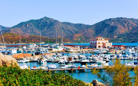 Old Sardinian Port and marina with ships at Mediterranean Sea in city of Villasimius in South Sardinia Island Italy in summer. Cityscape with Yachts and boatsの写真素材