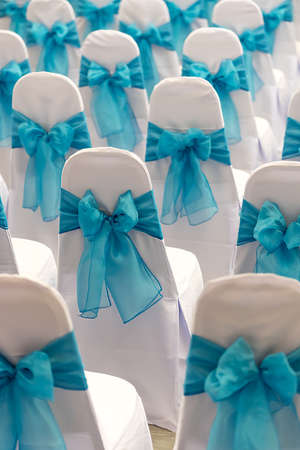 banquet chairs with blue ribbonsの写真素材