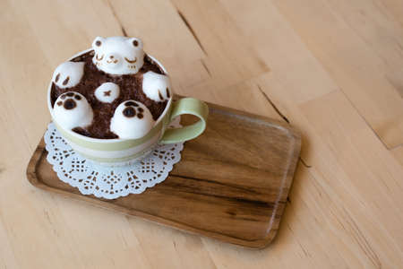 three dimention (3D) latte art on wooden tableの写真素材