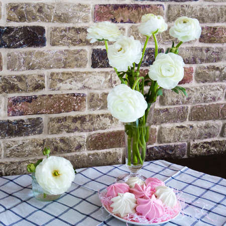 spring still-life with white flowers and meringuesの写真素材