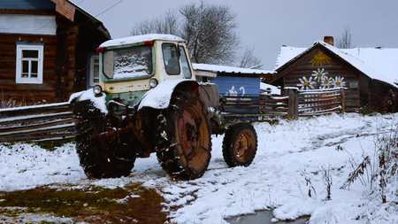 Tractor in a village. Winter. The farmer workの写真素材
