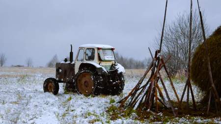 Tractor in a village. Winter. The farmer workの写真素材