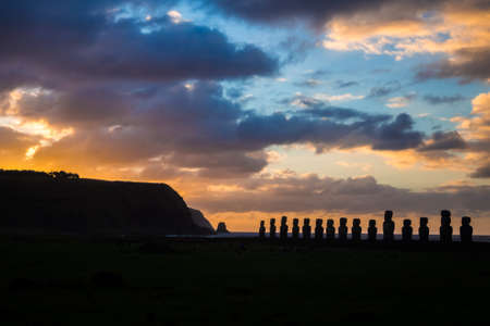 Sunrise at Ahu Tongariki in Easter Island. 15 moais shilouette and cloudsの写真素材
