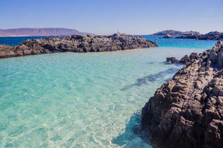 Blue water of English Bay in north of Chile. Detail of the beach an d the coast of the villageの写真素材