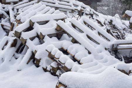 Wood and palets under the snow. Winterfieldの写真素材