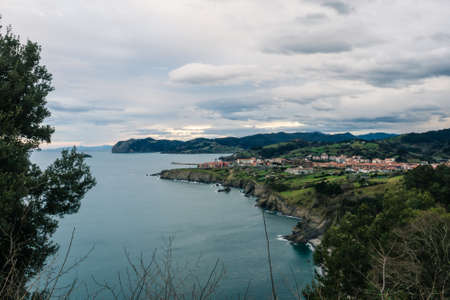 View of the coast of the village of Bermeo on a cloudy day, in the Basque Country, Spainの写真素材
