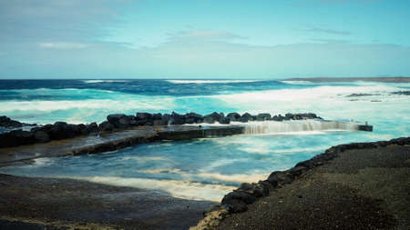 FEBRUARY/02/2019 Waves jumping on dock of the fishing cove of La Santa in Lanzarote during a storm, long exposure photography. CANARY ISLANDSのeditorial素材