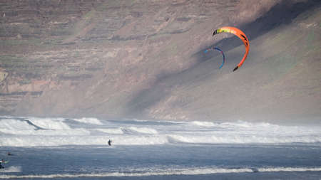 People doing kite surfing on the beach of famara in Lanzarote, Canary Islands