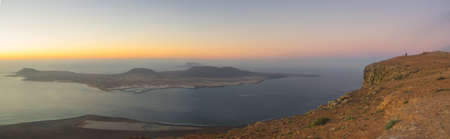 Panoramic view from the Mirador del Rio in Lanzarote during sunset with the island of La Graciosa....