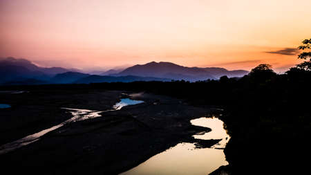 Landscape during the sunset in Villa Tunari, Bolivia. High contrast pic with the river and the mountains in the backの写真素材