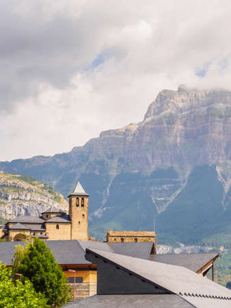 Torla Ordesa, church with the mountains at bottom, Pyrinees Spain vertical.の写真素材