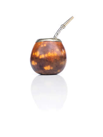 argentinian or uruguayian calabash for yerba mate and its bombilla isolated on white background....