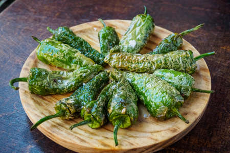 Fried Padron peppers tapa on a wooden boardの写真素材