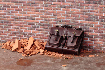 abandoned bag on a brick wallの写真素材