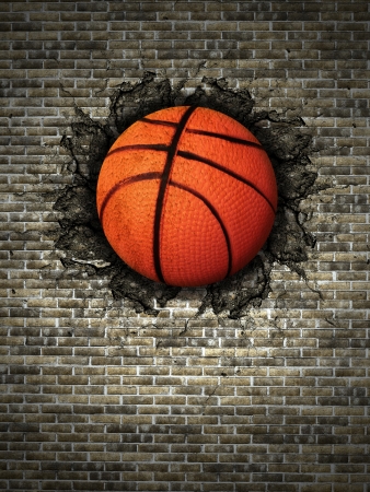 basketball embedded in a brick wallの写真素材