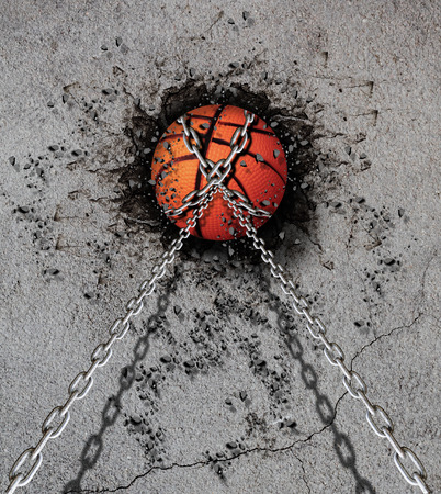 basketball embedded in a concrete wallの写真素材