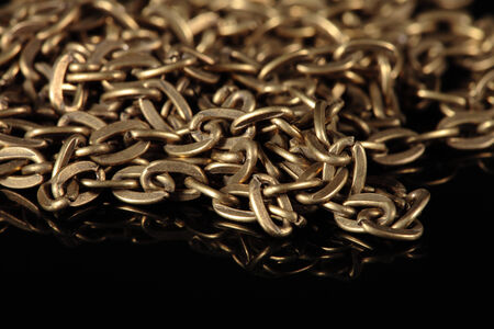 detail of a gold chain on a black 