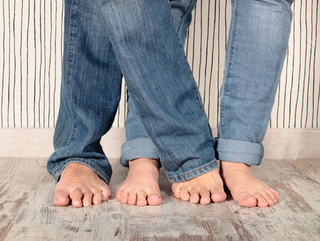 man and woman barefoot with jeansの写真素材