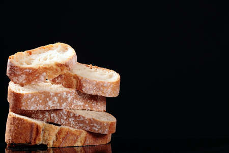 delicious wheat bread isolated on blackの写真素材
