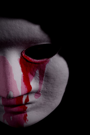macabre scene with a mask and bloodの写真素材