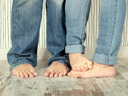 man and woman barefoot with jeans