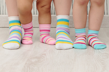 feet of a beautiful family with striped socksの写真素材