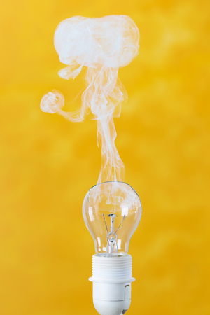 bulb exploding with fire and smokeの写真素材