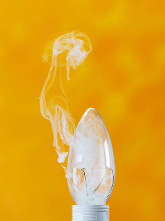 bulb exploding with fire and smokeの写真素材