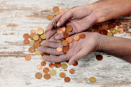 a poor hands taking some coinsの写真素材