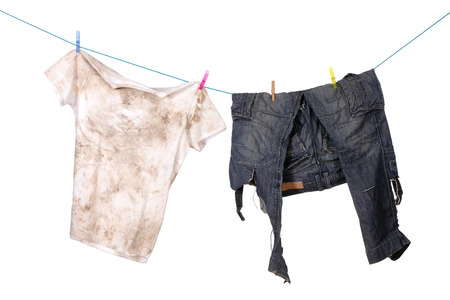 dirty shirt and trousers hanging to dryの写真素材