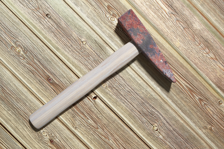 3d rendering of an old hammer on a wood tableの写真素材