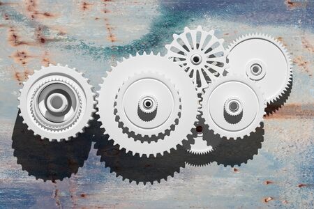 3d rendering of some gears on a rusty surfaceの写真素材