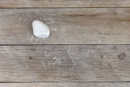 White stone on a wooden surfaceの写真素材